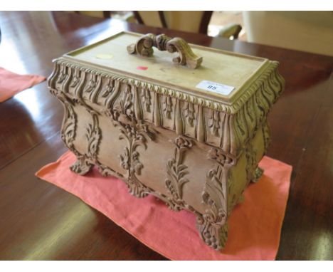 An unpolished mahogany bombe form tea caddy, with acanthus carving and carved bracket feet, the lid with scroll handle, the i