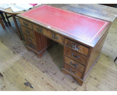 A mahogany pedestal desk, the leather inset top over three drawers, each pedestal with a further three drawers and bracket fe