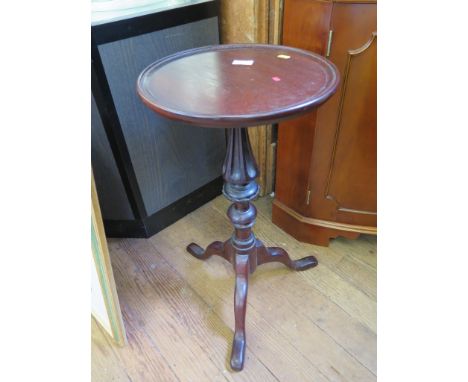 A mid Victorian style mahogany tripod table, on a turned and fluted stem and cabriole legs, top 35cm diameter