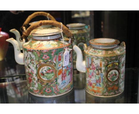 Two Chinese famille rose cylindrical teapots with panels depicting families and birds, one teapot lacking swing handle, 20cm 