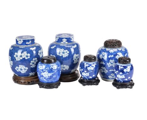 A pair of Chinese blue and white ginger jars and covers, 19th century, in Kangxi style, painted with prunus flowers on a 'cra