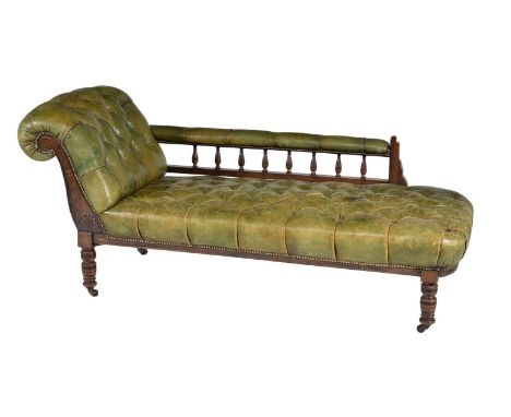 A late Victorian walnut and green leather button upholstered chaise longue, circa 1890, the upright to the scrolled end with 