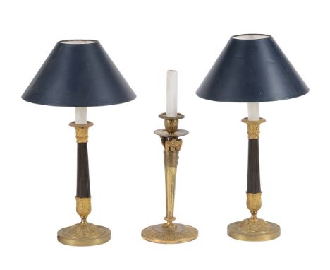 A pair of parcel gilt and patinated metal table lamps in the manner of Charles X candlesticks, second quarter 20th century, w