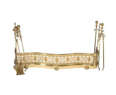 A cast and pierced brass fender in George III style, 19th century, of serpentine outline, the openworked and beaded frieze ca