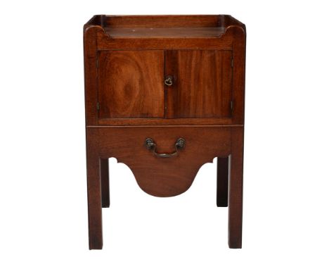A George III mahogany night commode, circa 1780, the tray top incorporating handles above a pair of drawers and slide to the 