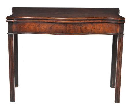 A George III mahogany card table, circa 1770, of serpentine outline and in the manner of Thomas Chippendale, 75cm high, 97cm 