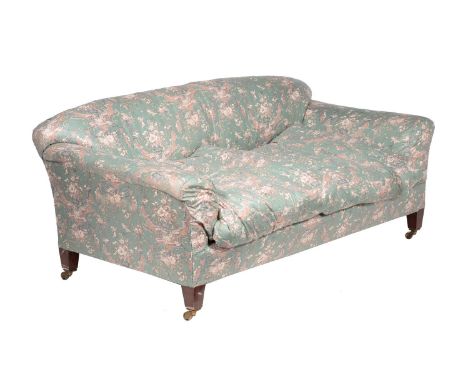 A mahogany and upholstered two seat sofa in Victorian taste, and in the manner of Howard &amp; Sons, the button upholstered s