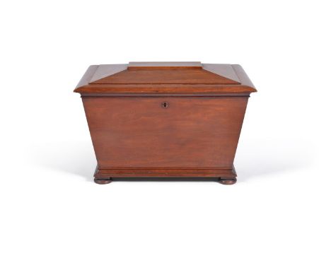 A William IV mahogany wine cooler, circa 1835, of sarcophagus form, the chamfered hinged opening to an interior with a later 