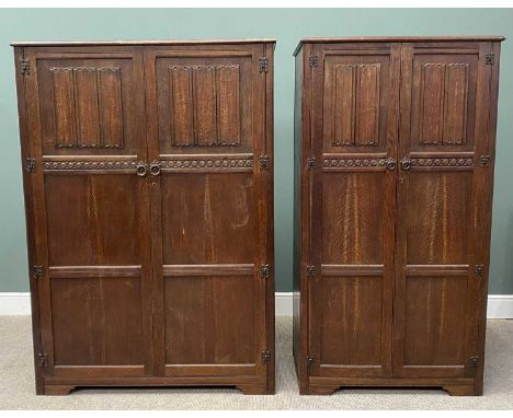 TWO PRIORY OAK-STYLE LADY'S &amp; GENTS WARDROBES, having linenfold carved upper panels, ironwork hinges and ring pull handle