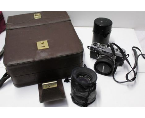 Olympus OM-1n Camera in case together with three Olympus lenses