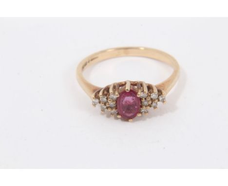 9ct gold ruby and diamond cluster ring with a central oval mixed cut ruby with diamonds set to each side in claw setting, rin