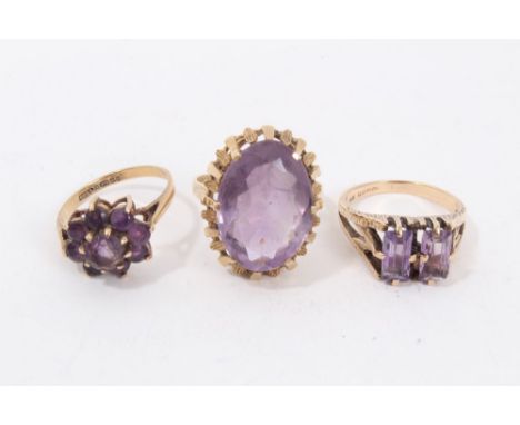 Three 9ct gold amethyst dress ringsCondition report: Total weight 10.8g Oval cocktail ring size P½. Cluster ring size L. Two 