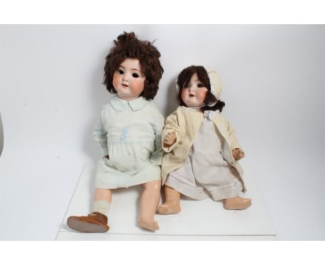 Two German Bisque head dolls together with clothing including Heubach Koppelsdoft 320 .7 with wobbly tongue. Both dolls 55 cm