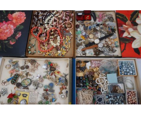 Four vintage cardboard chocolate boxes containing costume jewellery, paste set brooches, bead necklaces and three gentlemen’s