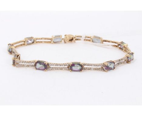 9ct gold mystic topaz and diamond bracelet with ten rectangular step cut mystic topaz interspaced by two rows of diamond set 
