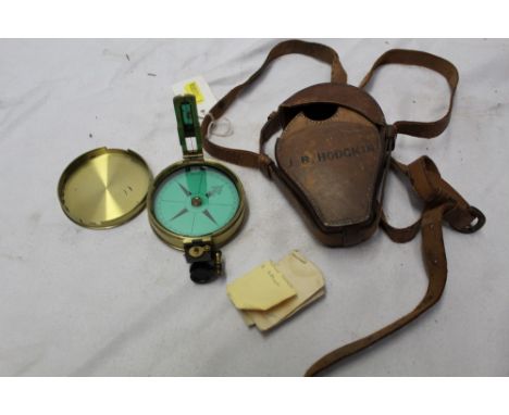 19th century prismatic compass with green printed floating compass and folding open sight, in a circular brass case with slip