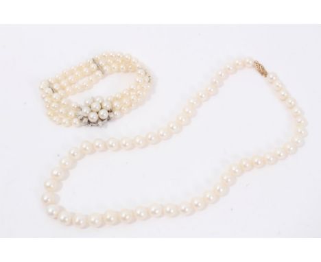 Cultured pearl single strand necklace with a 14ct gold clasp, together with a triple strand pearl bracelet with flower head c