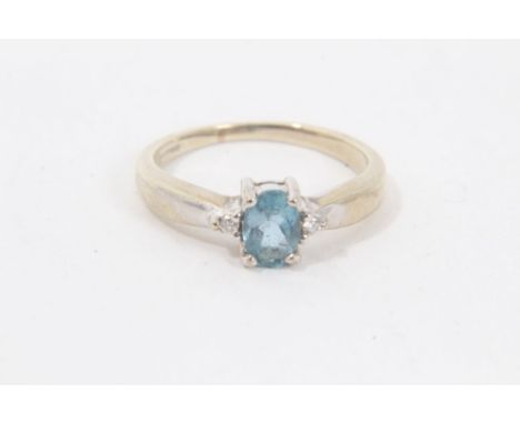 9ct white gold aquamarine and diamond ring with a central oval mixed cut aquamarine flanked by a brilliant cut diamond to eac