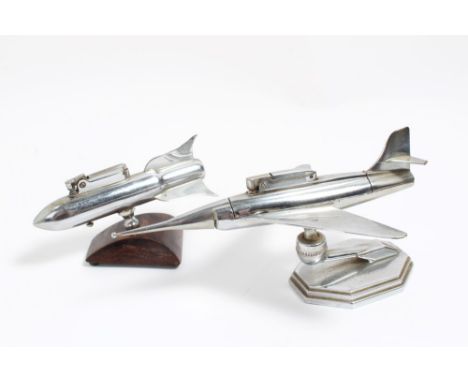 Two vintage chrome lighters, one in the form of a missile and the other a jet