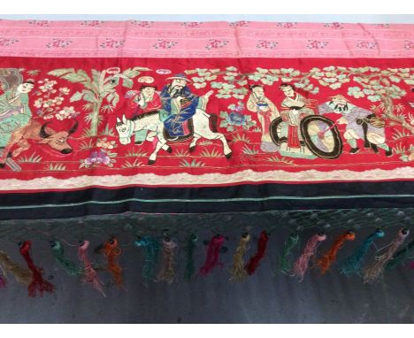 Chinese embroidered red silk panel c.19th century with couch and satin stitches, garden scene with figurers, animals, trees a