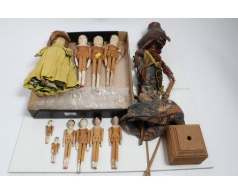 Group of Antique Grodnertal peg dolls, four large and six smaller ones, together with a Balinese stick puppet