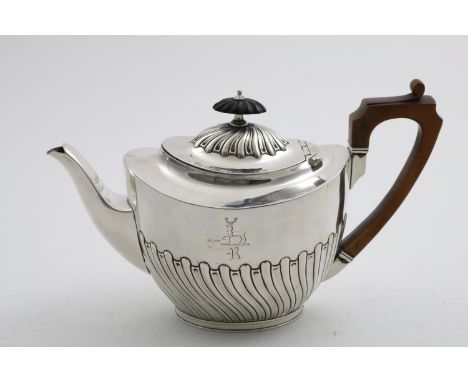 A LATE VICTORIAN PART-FLUTED TEA POT oval, with an angular wooden handle, crested &amp; initialled "R" by Elkington &amp; Co.