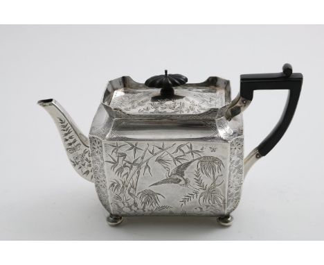 A VICTORIAN RECTANGULAR TEA POT with panelled sides, button feet and incurved corners, engraved all over in the Japanese tast