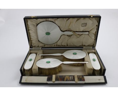 AN EDWARD VIII ART DECO DRESSING TABLE SET decorated with pearlescent enamel and carved jadeite bosses in original fitted box