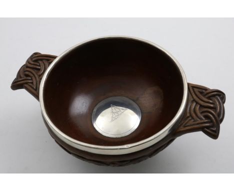 A LATE VICTORIAN SCOTTISH PROVINCIAL, LARGE MOUNTED WOODEN QUAICH carved on the handles and around the sides with Celtic knot