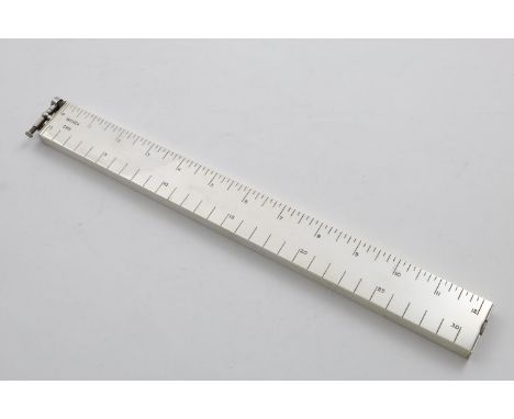 AN ELIZABETH II PLATED LIGHTER  in the form of a rule, calibrated in centimetres and inches, by Dunhill and Co., c.1955 (in o