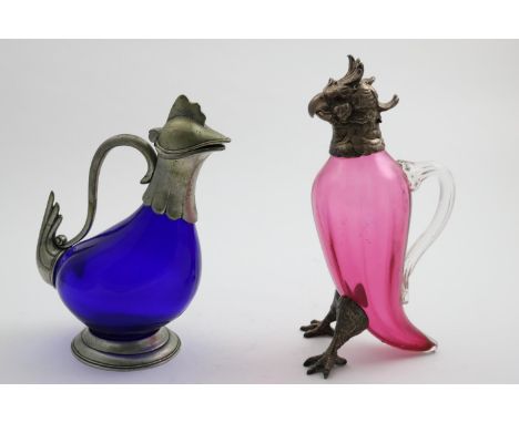 A LATE 19TH CENTURY PLATED MOUNTED RUBY GLASS CLARET JUG in the form of a cockatoo (hinge A/F), and another plated-mounted gl