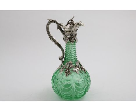 AN EARLY VICTORIAN MOUNTED CUT-GLASS CLARET JUG with a vivid light green coloured, baluster body and a fruiting vine mount an