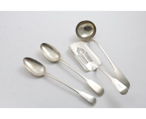 FOUR ANTIQUE FIDDLE PATTERN SERVING PIECES:- An Irish fish slice, crested, Dublin 1825 (maker's mark partially rubbed, retail