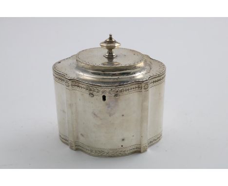 A GEORGE III TEA CADDY  with an oval, serpentine outline, engraved borders and a knop finial, the base inscribed "In memory o