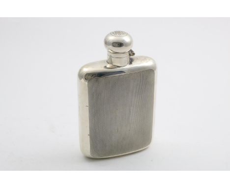 AN ART DECO LARGE SPIRIT FLASK of rounded rectangular outline, with an engine-turned front &amp; back and a hinged, twist-ope