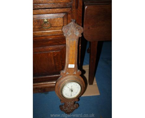A carved Oak aneroid Barometer (thermometer absent), 26 1/2'' overall