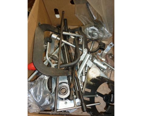 A box of motorcycle spares including; clamps, bearings, footrest, 'T' braces/spanners, 'Yamaha' pawl tool, rear sprocket, lar