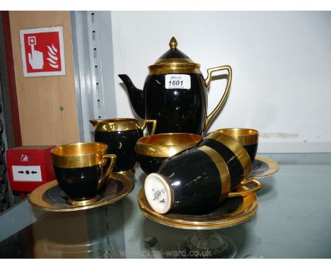 A Carltonware black and gold coffee set.