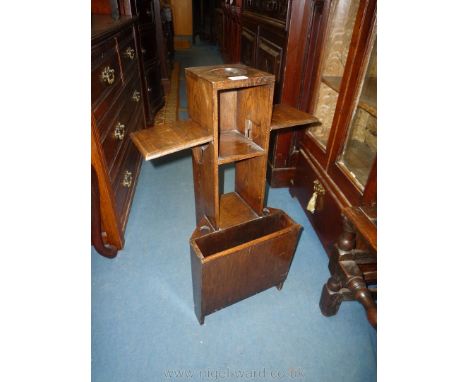 An arts and crafts Oak Smoker's Stand/Shelf unit with magazine recess to the base and pair of hinged shelves, 11 3/4'' wide x