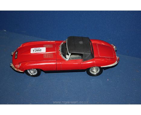 A Tonka Polistil Jaguar E type Roadster series 1 model, 1:18 scale in red with black interior, live steering wheel, lifting b