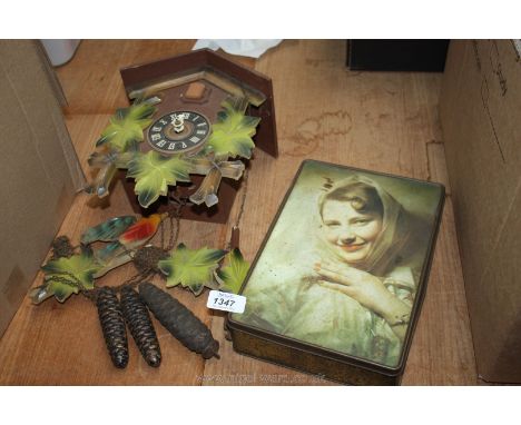 A Cuckoo CLock, weights and old tin