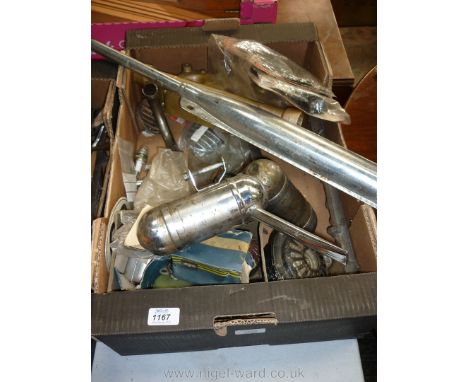 A box of spares including Saab 3 cylinder two stroke cylinder head, three motorbike exhausts and silencers, two Saab owners c