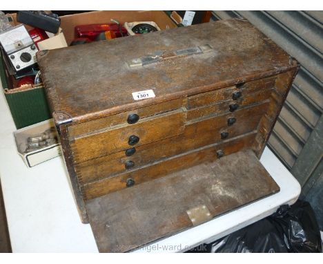 A fall front wooden Tool Chest of five short and three long drawers (20'' x 13 1/2'' x 9'' deep) containing a good quantity o