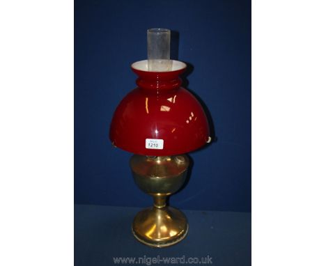 A brass Oil Lamp, complete with red shade. 