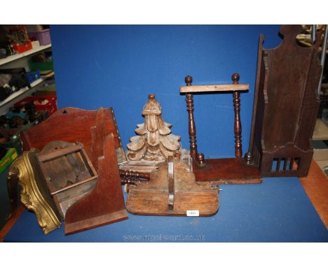 A gold coloured painted wall shelf, two other wooden shelving units, etc.