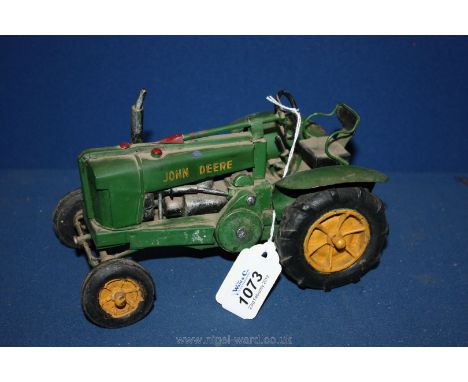 An old tin green Tractor model (John Deere)