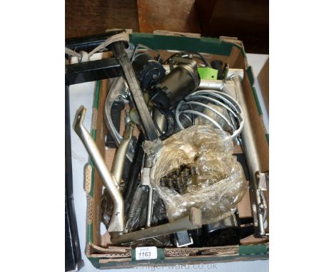 A box of motorcycle spares including two pairs of rear swinging arms, pedals, new drive chain, hinged rest/stand, number plat