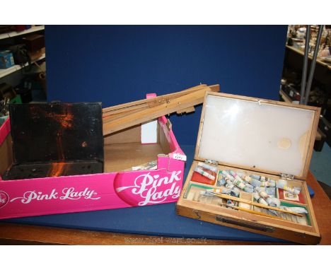 An artist's easel, two artist paint boxes and a quantity of paints, palette, etc.