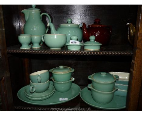 A quantity of Denby ware in sage green including coffee pot, tea pot, meat plates, small serving dishes, egg cups, etc.