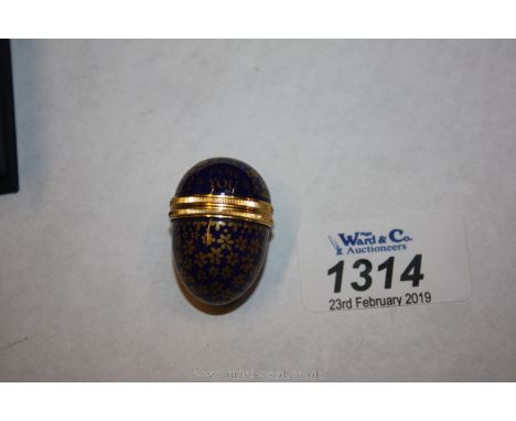 A blue enamel Halcyon Days egg.